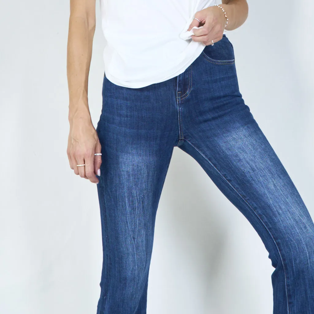 Trendy high-waisted flared jeans with raw hem wholesale