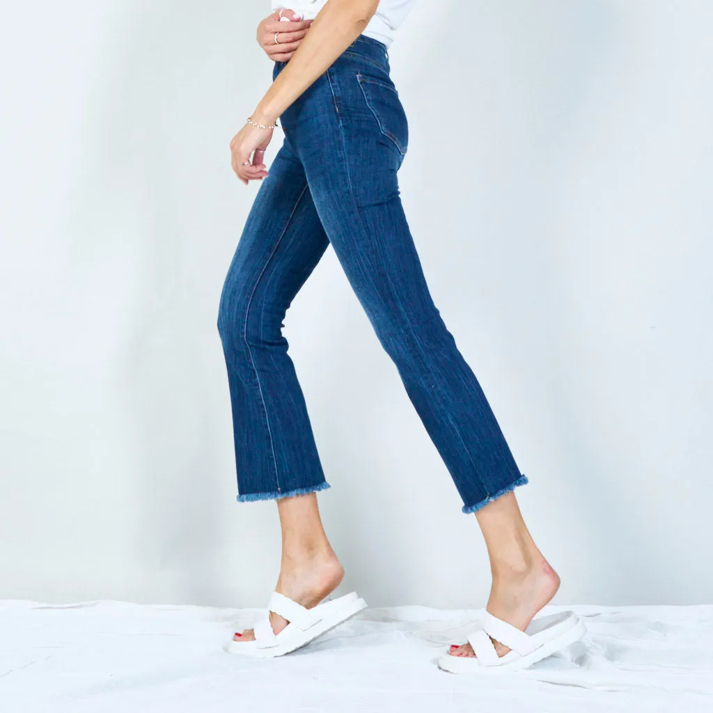 Trendy high-waisted flared jeans with raw hem wholesale