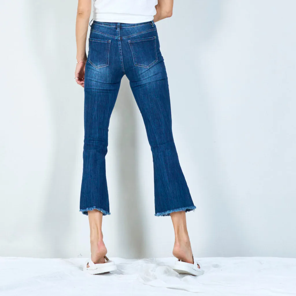 Trendy high-waisted flared jeans with raw hem wholesale