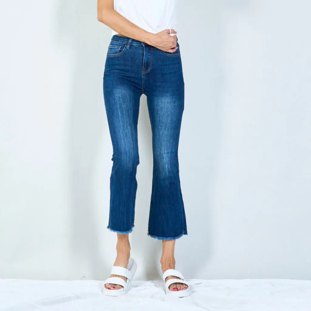 Trendy high-waisted flared jeans with raw hem wholesale